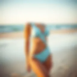 Stylish powder blue swimsuit displayed on a sandy beach
